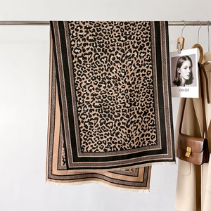 Close-up of leopard print scarf with fringe trim and soft cashmere-like texture