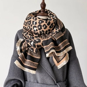 Detailed view of the leopard print cashmere scarf with handmade fringed tassels