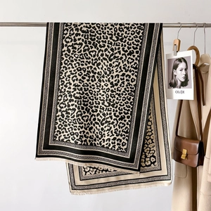 Close-up of leopard print scarf with fringe edges and premium cashmere-like texture