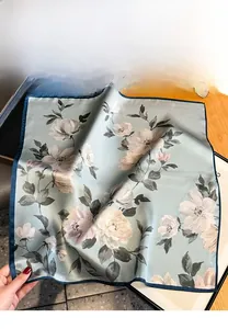 Dettaglio macro di un foulard in seta di lusso con stampa floreale e trama satinata