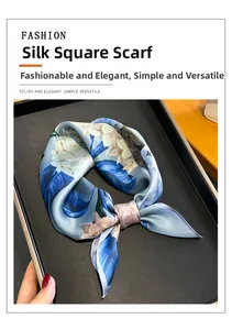 Detailed view of a light blue silk square scarf with elegant white floral print patterns