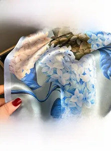 Detail shot of the fine stitched edges and premium floral silk scarf texture