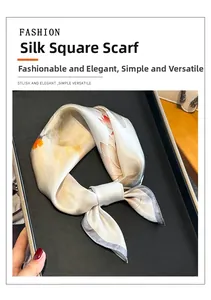 Detail of silk square scarf featuring elegant lotus floral prints and a metal buckle ring