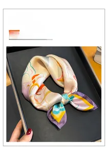 Macro detail of silk square scarf featuring Dunhuang style patterns and high-density texture