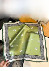 Detail of green floral square silk scarf with vintage white flower patterns