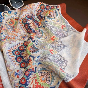 Elegant paisley floral printed scarf with double-sided orange and blue silk texture
