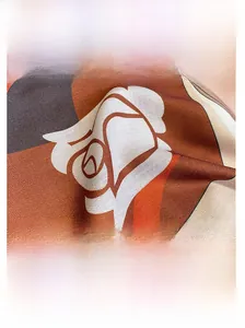 Detail view of contrast floral print silk scarf showing fine edge stitching and texture