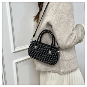 Detalle de bolso acolchado blanco con tachuelas plateadas y elegante correa de cadena