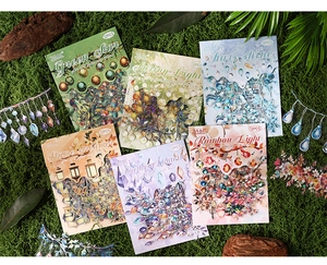 Close-up of 6 themed sets of decorative transparent stickers for DIY scrapbooking