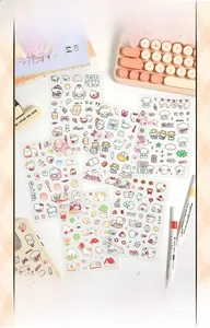 Close-up of cute cartoon bear and bunny stickers on a phone case with desk accessories