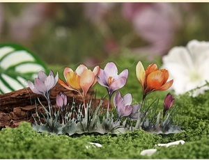 Macro detail of transparent saffron flower acrylic ornaments in a mossy woodland setting