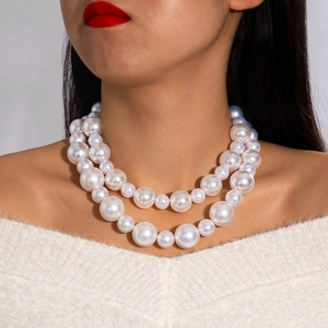 Double-layered white pearl necklace featuring a baroque metal pendant for elegant women