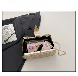Detailed interior of a gold leaf clasp evening clutch with phone and lipstick storage