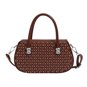 Bolso marrón acolchado con cuentas y asas superiores, estilo minimalista otoño 2025