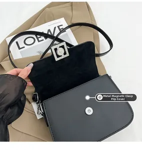 Detail view of the secure magnetic buckle flap closure on a black matte leather bag