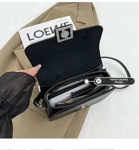 Interior view of black leather shoulder bag showing compartments and zipper pocket