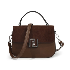 Brown leather and frosted suede handbag with silver metal buckle on white background