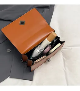 Detail view of the multi-compartment interior for this brown leather crossbody bag