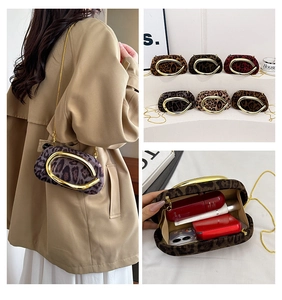 Detail view of leopard print faux suede box clutch with gold metal chain and ring handle