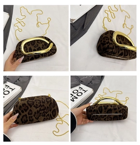 Detail view of leopard print clutch featuring gold metal handle and chain strap