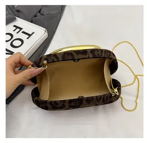 Detailed interior view of a leopard print clutch bag with gold chain and round handle
