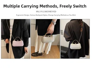 Detailansicht der gewebten Box-Clutch mit Metallgriff und eleganter Kettenriemen