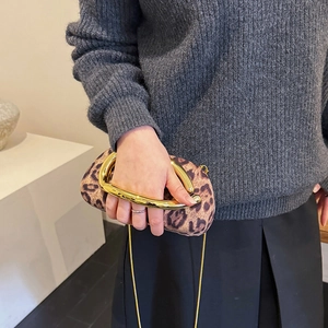 Leopard print faux suede clutch with large gold metal handle and chain shoulder strap