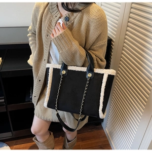 Winter faux shearling tote bag with leather straps shown in a lifestyle street setting