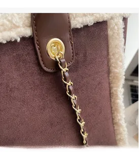 Detail of brown suede tote bag with white fleece trim and gold chain shoulder strap
