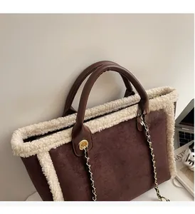 Detail of lamb wool trim on brown suede tote with leather handle and gold chain