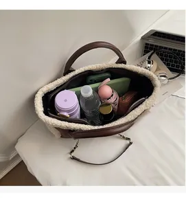 Top view of spacious lamb wool patchwork tote bag interior with diverse daily essentials