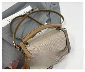 Close-up of saddle bag details with woven texture and premium brown leather trim