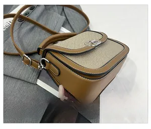 Detail view of precise stitching on two-tone saddle bag with premium leather texture