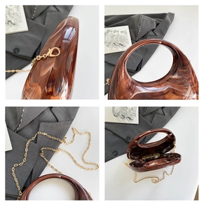 Detail view of acrylic chain bag with brown marble texture and gold chain strap