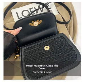 Detail of black woven crossbody bag with gold magnetic clasp and adjustable strap