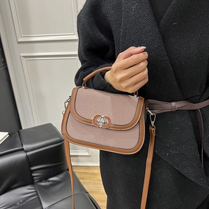 Brown fabric patchwork saddle bag with silver clasp and detachable shoulder strap for women
