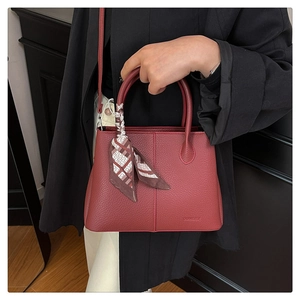 Elegant red leather tote bag with silk scarf accessory for fashionable commuting
