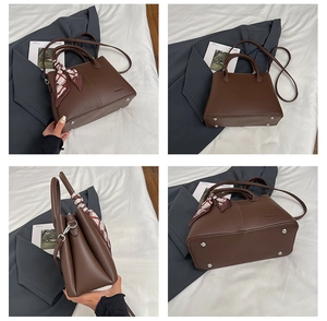 Detail view of large coffee brown tote bag with silk scarf and metal bottom studs