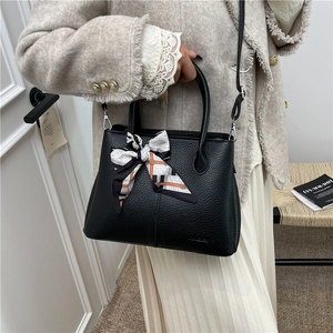 Classic black litchi pattern leather tote bag with stylish geometric silk scarf detail