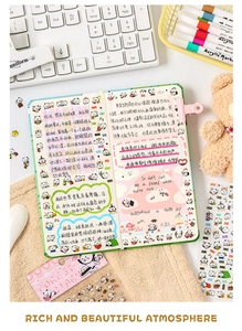Flat lay of cute panda themed journal stationery set with stickers and clips
