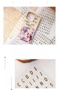 Macro detail of vintage gold foil alphabet stickers for DIY scrapbooking and crafts