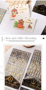 Detail of gold and silver foil letter stickers on vintage postcard for journaling