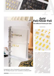 Detail of gold and silver foil letter stickers on a clear grid textured binder notebook