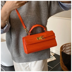 Detail of orange woven texture mini bag with gold-tone twist lock and adjustable strap