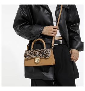 Detail of retro leopard print crossbody bag with metallic lock and slim shoulder strap