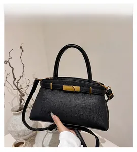 Detailansicht der schwarzen Handtasche aus Leder mit edlem goldenem Metallverschluss