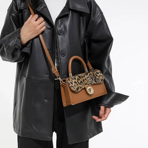 Vintage leopard print crossbody bag with brown leather and golden twist lock closure