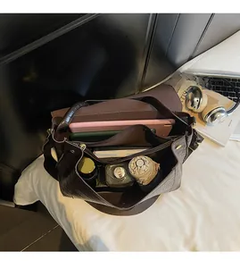 Interior view showing large capacity and zipper pocket of dark brown crocodile pattern tote