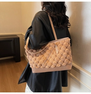 Detail of apricot faux fur tote bag with textured plush surface and smooth leather strap