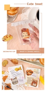 Detail showing cute cat toast stickers applied on a glass cup and decorative card